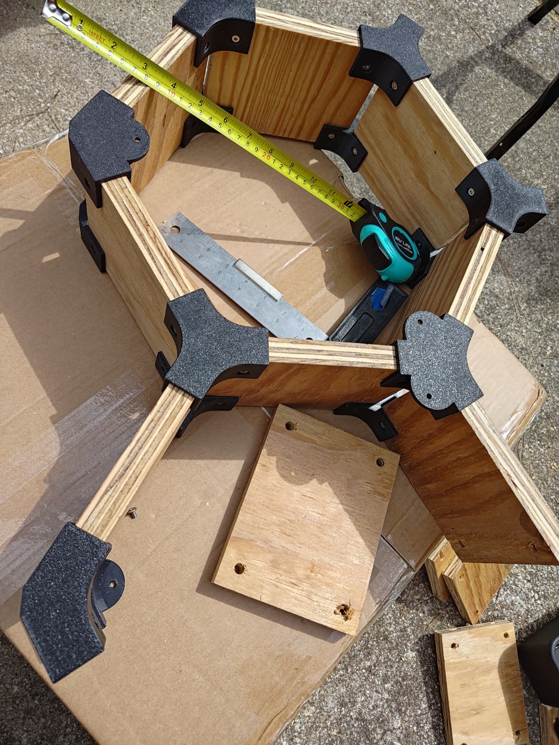 Close view of plywood boards, printed connectors and fastener heads during a fit test